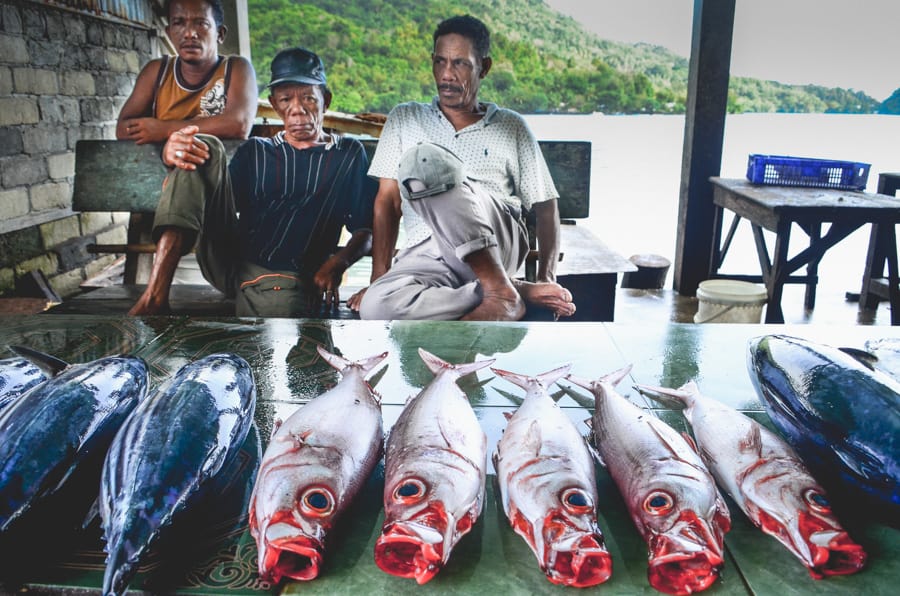 Fishermen with fish at the fish market in Bandaneira, Indonesia