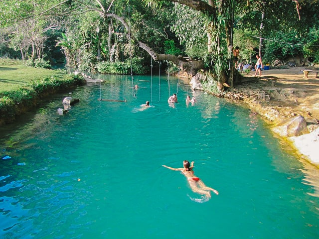 Tourist swimming in the Blue Hole swimming spot in Vang Vieng, Laos