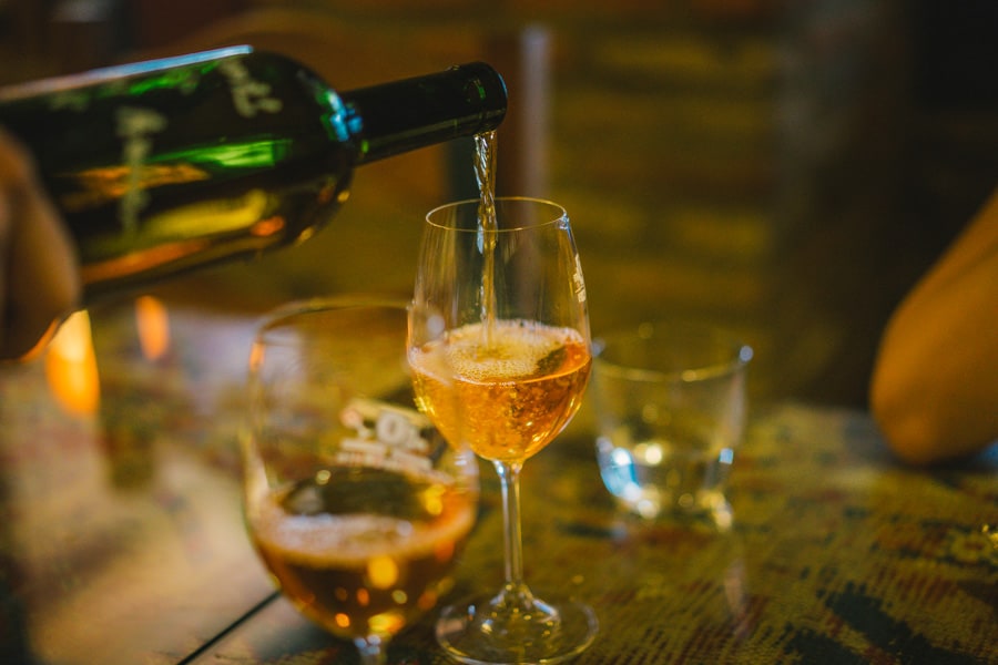 A glass of amber wine being poured at Pheasant's Tears in Sighnaghi, Georgia