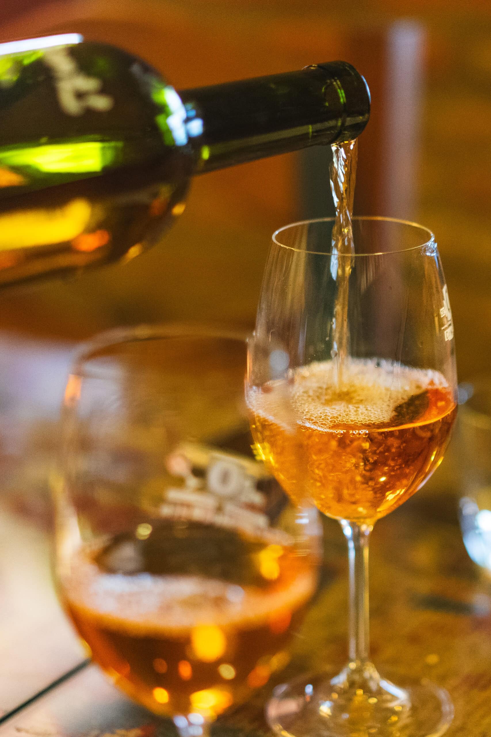 A glass of amber wine being poured in Sighnaghi Georgia. 