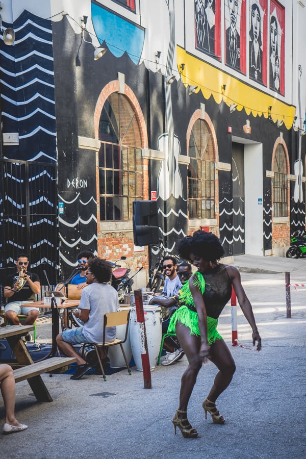 A woman dances to a Samba band at LX factory in Lisbon