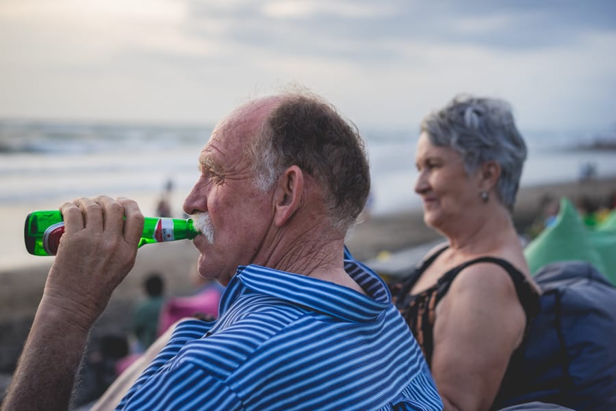 dad drinking a Bintang beer on Canggu Beach