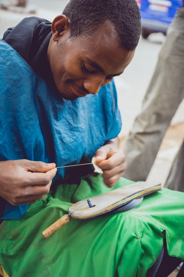 A man fixing shoes on the street in Harar, Ethiopia