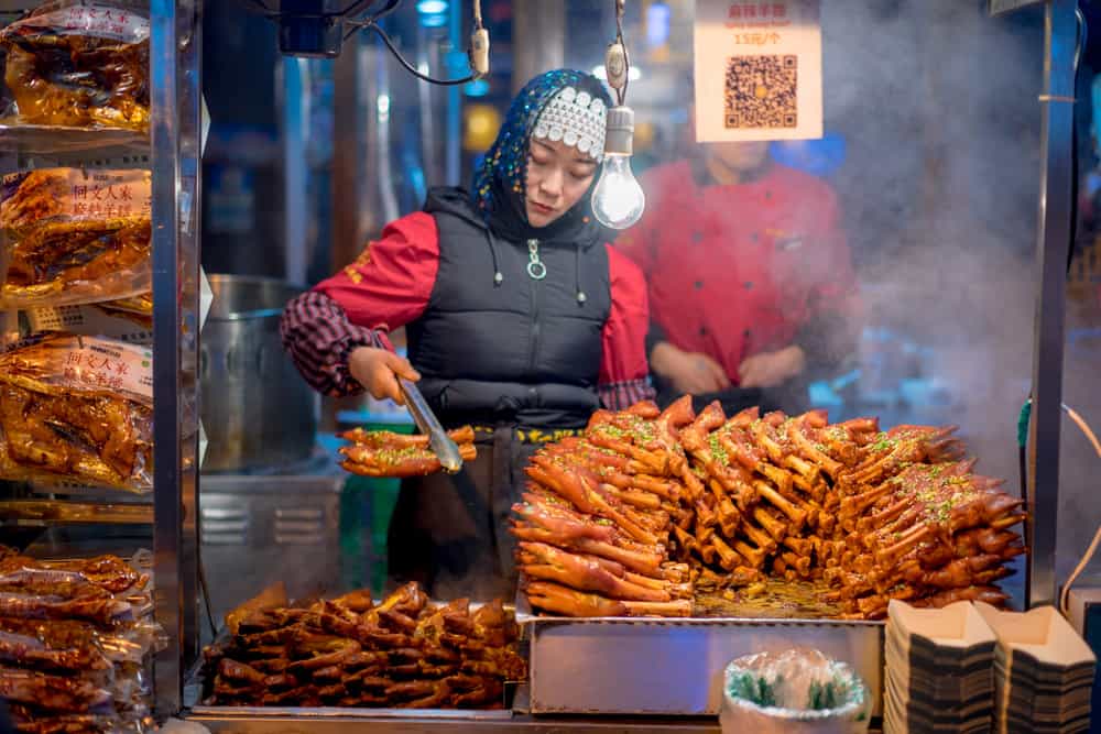 A woman selling street food on Muslim street in Xi'an