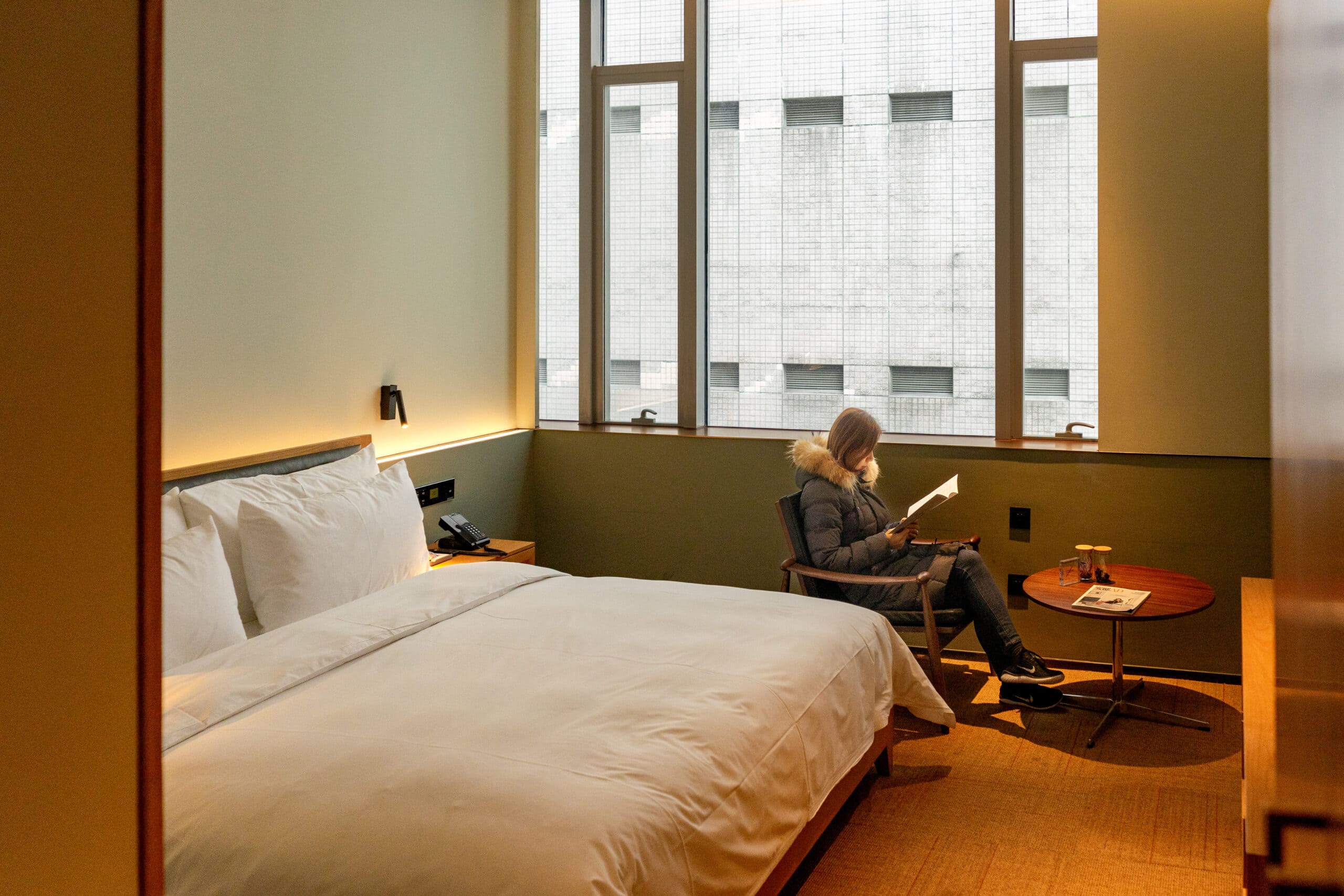 Jin sits and read inside our room at the Sfeel Designer Hotel. It's a boutique hotel near Tianfu Square in Chengdu