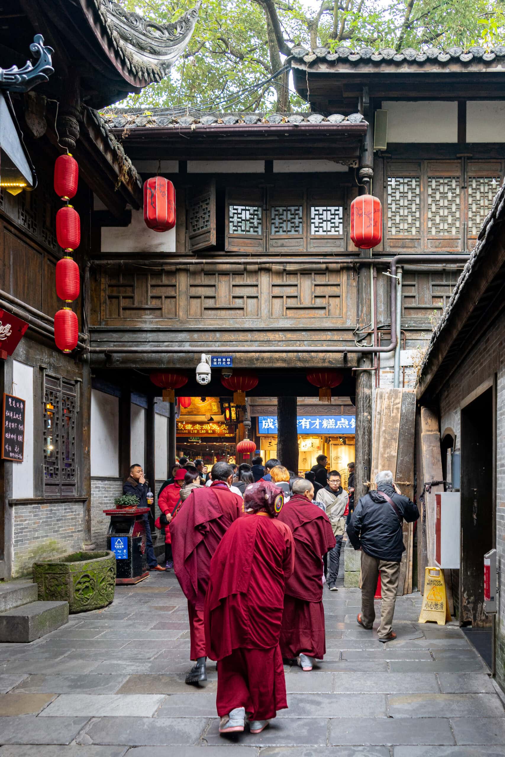Monks in red robes walking along Jinli Street in Chengdu, China