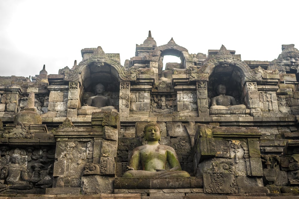 Budha statues on a temple, Java Indonesia. Many of the buddha statues have no heads, as they were looted and probably on display private collections or museums in the west