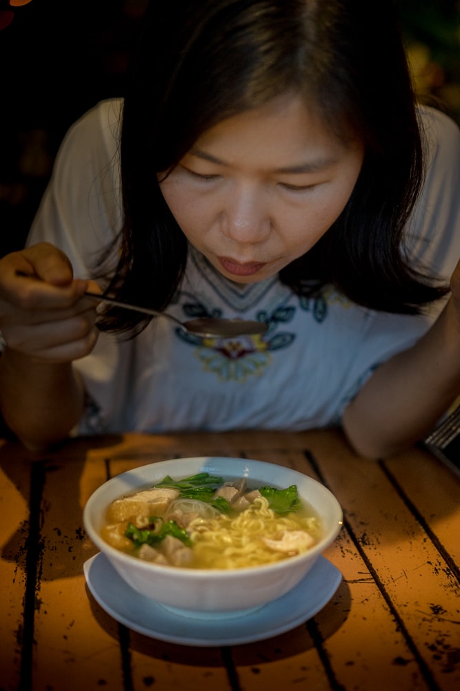 woman eating bakso in Yogyakarta