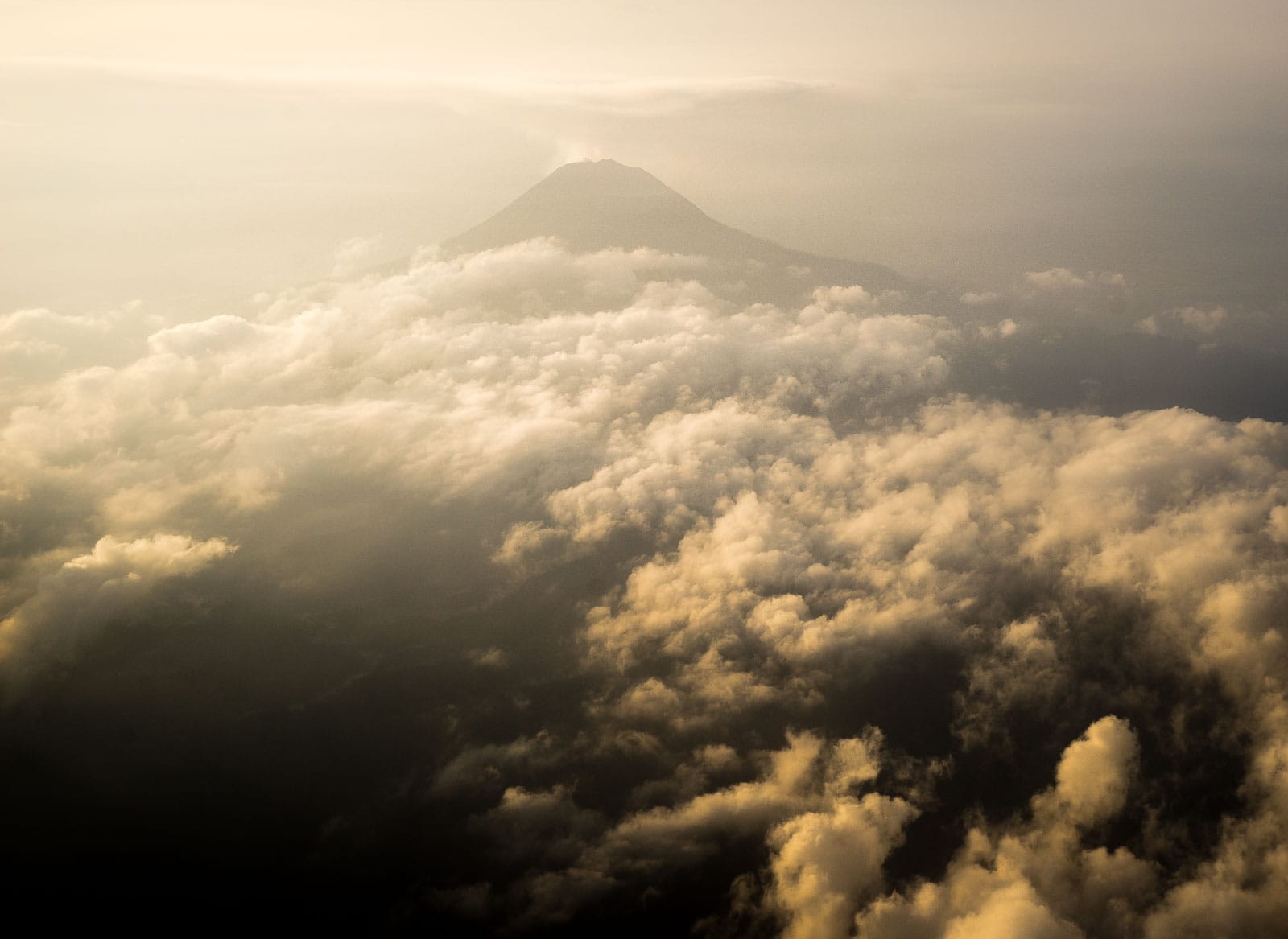 A smoking volcano seen from a flight between Medan and Nias island in Sumatra, Indonesia