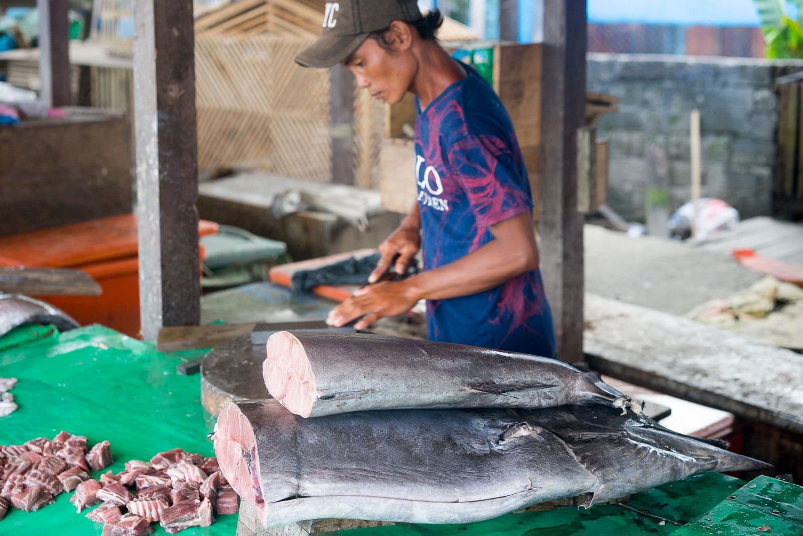 Man slicing a swordfish at a fish market in Gunungsitoli on Nias island, Sumatra 