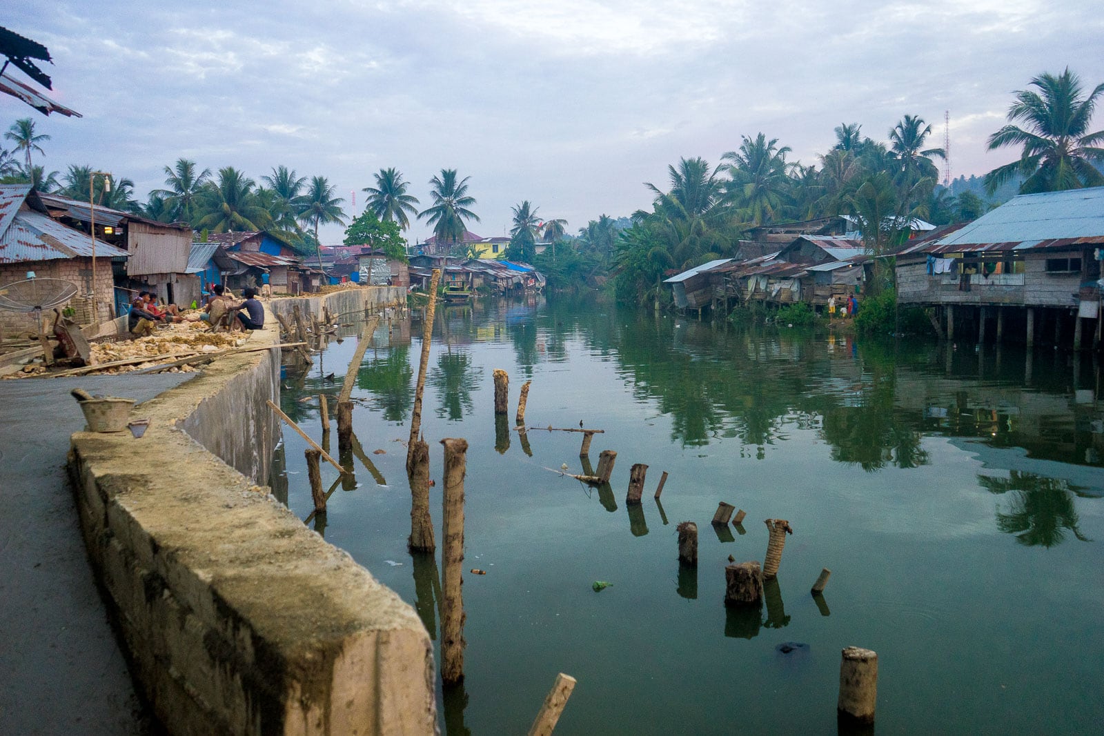 Scene with canal and houses on stilts in the city of Gunungsitoli on Nias island, Sumatra