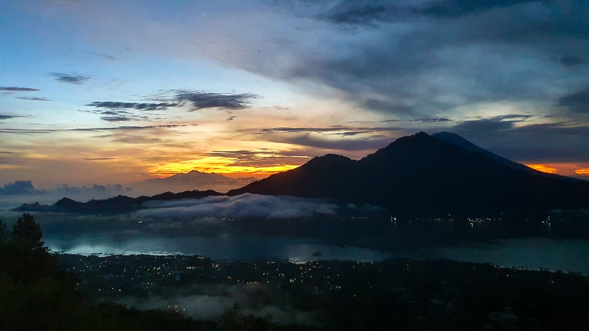 Kintamani, Bali at sunrise from Mount Batur. Travellers looking for a quiet holiday with some activities should consider Kintamani when deciding where to stay in Bali