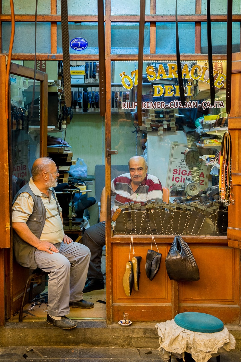 Two men chatting at a leather shop in a market in Gaziantep