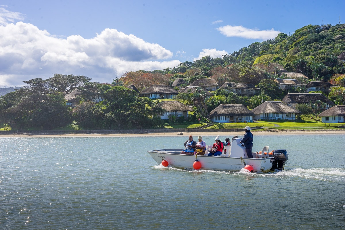 People crossing the uMngazi River by boat at the uMngazi Hotel in the Transkei