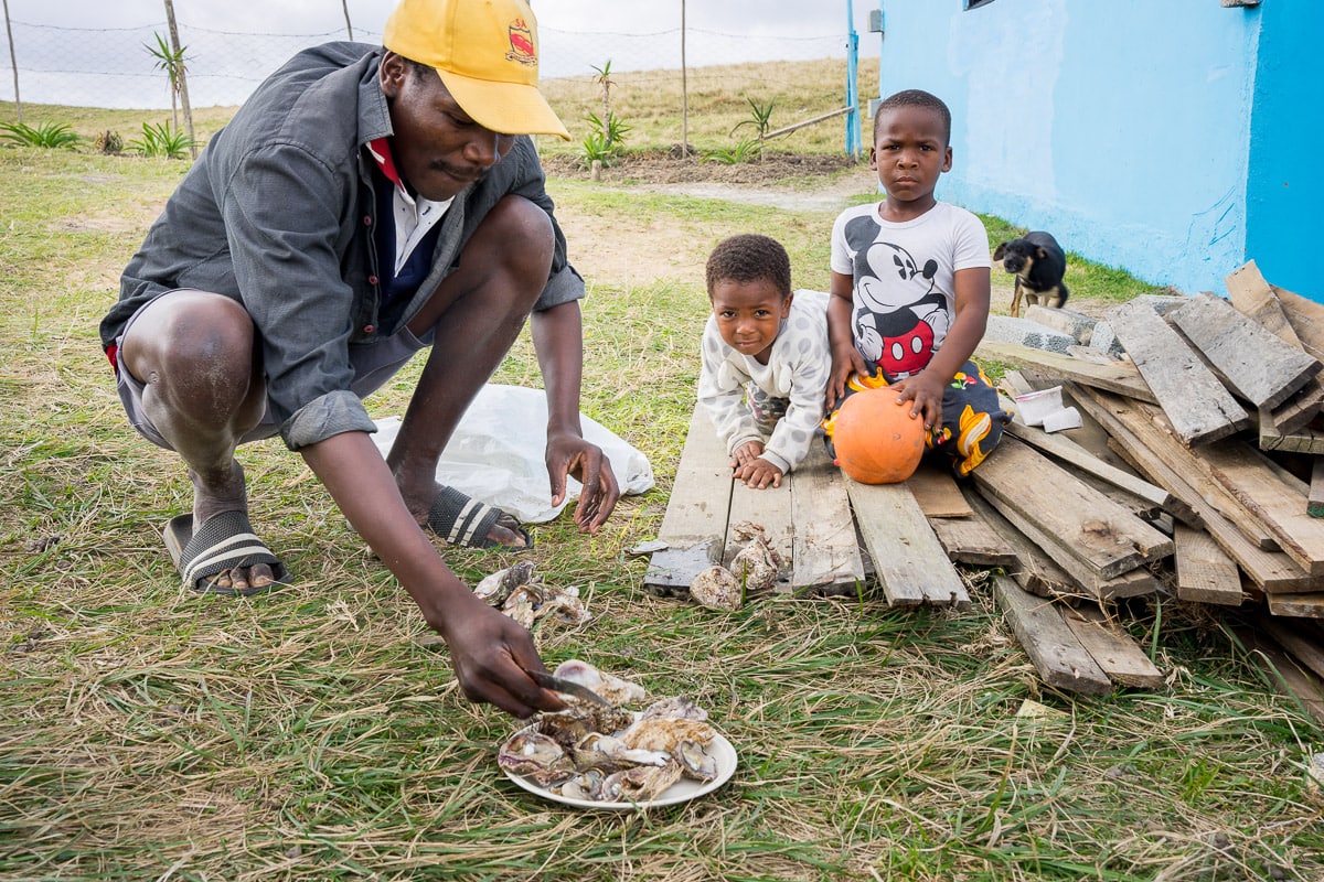 Man shucking oysters in Mdumbi, South Africa