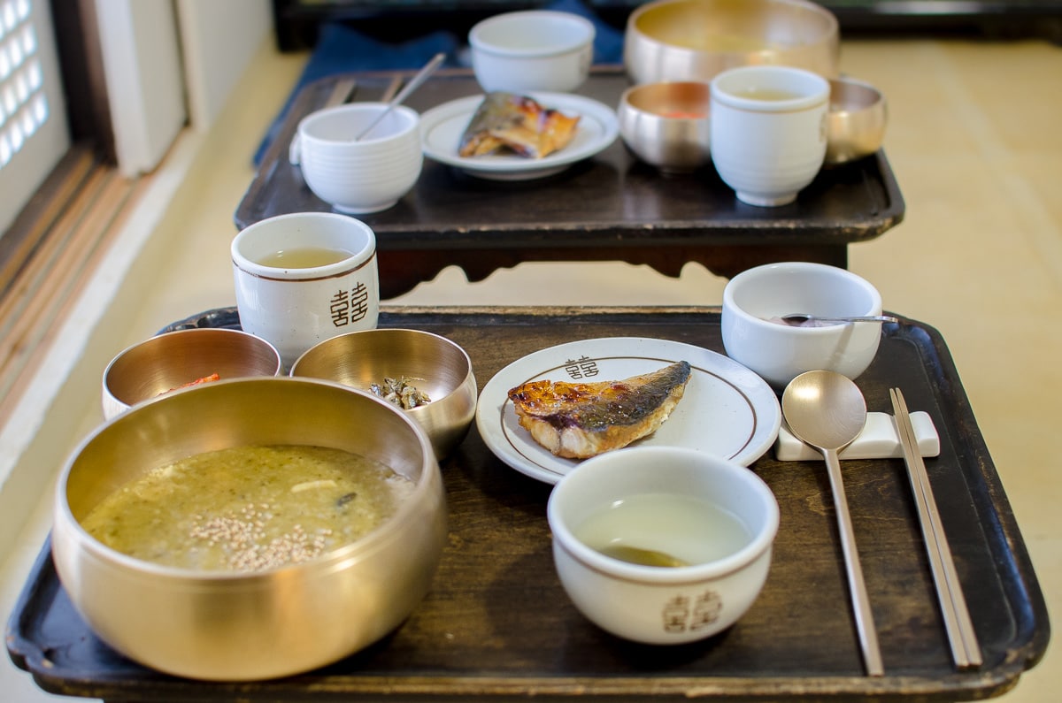 Traditional Korean breakfast of grilled mackerel, rice porridge, yoghurt and tea