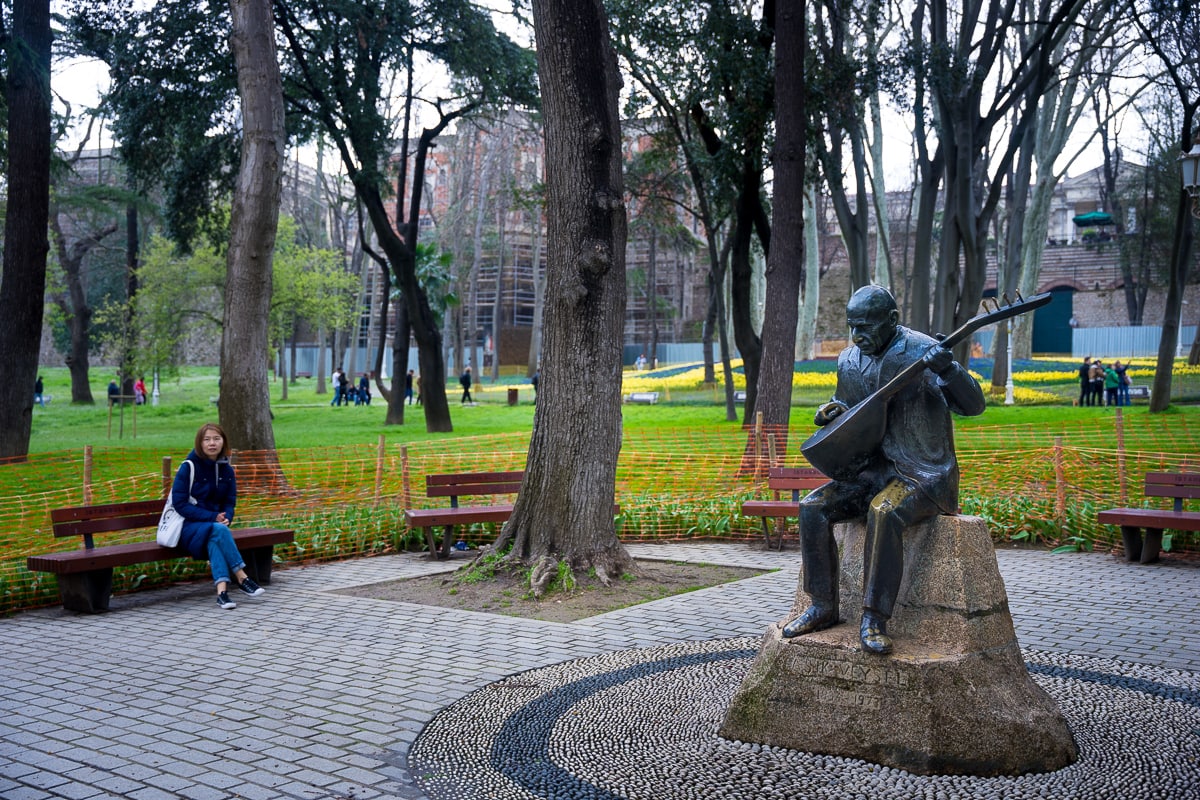 Jin sits on a bench in Gülhane Park in the centre of Istanbul