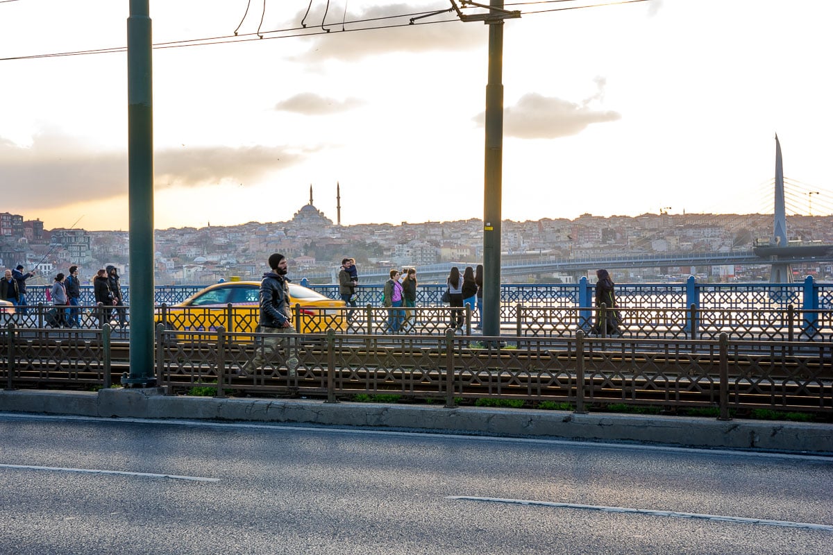 Pedestrians and cars cross the Galata Bridge in Istanbul