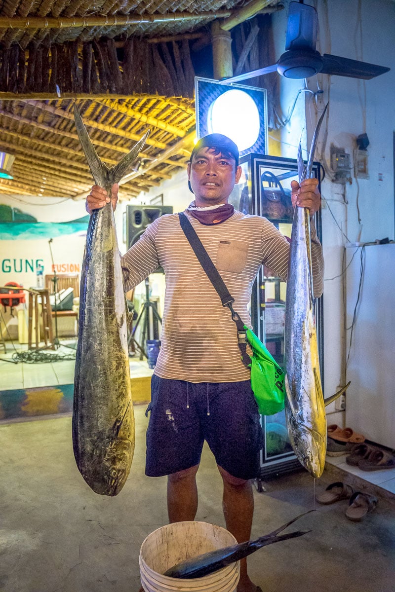 A fisherman with mahi mahi in Amed