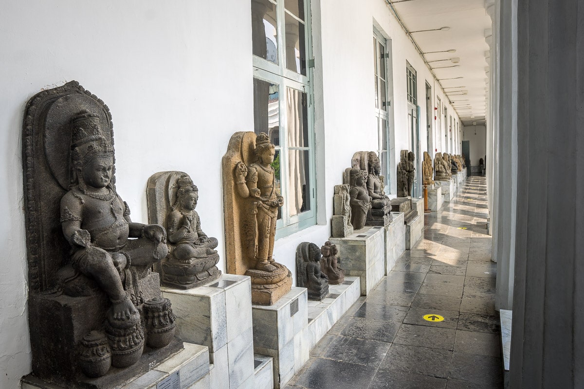 Statues are displayed on the porticos of the National Museum Indonesia in Jakarta. They are all from the Hindu-Buddhist era and carved from stone