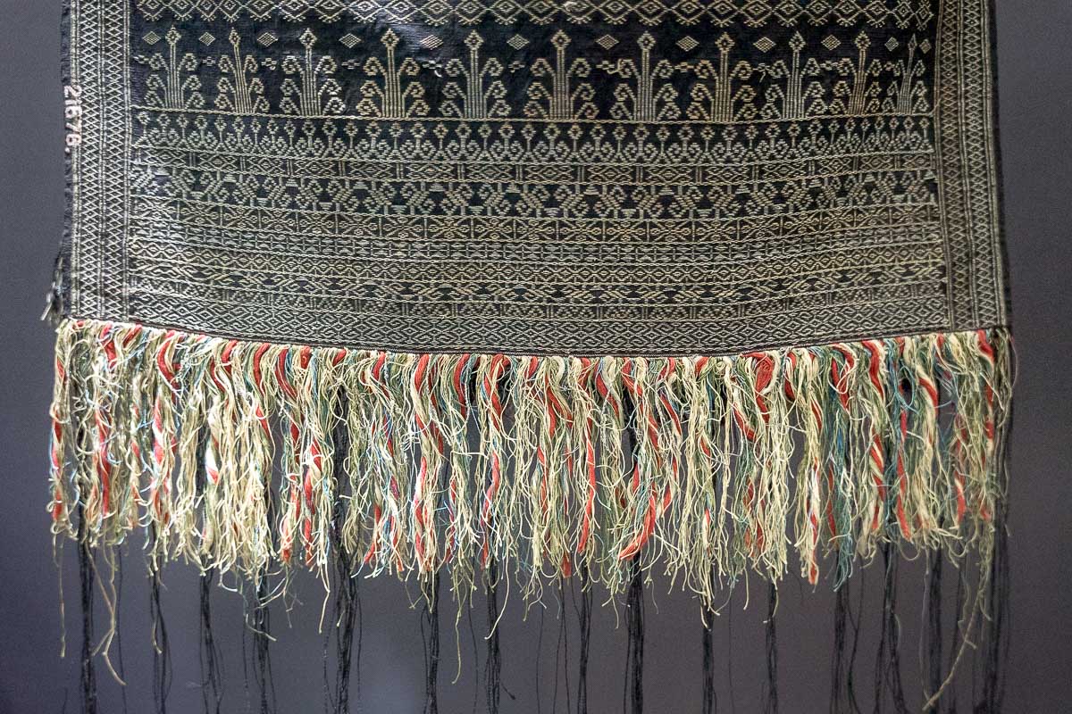 A handwoven batik cloth in blue and white on display as part of the textile exhibit at the National Museum of Indonesia