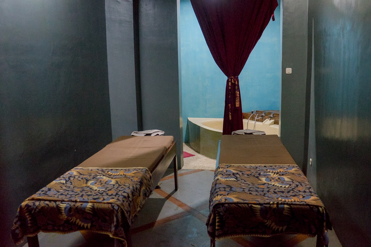 Two massage beds covered with batik clothes at Wae Molas Spa