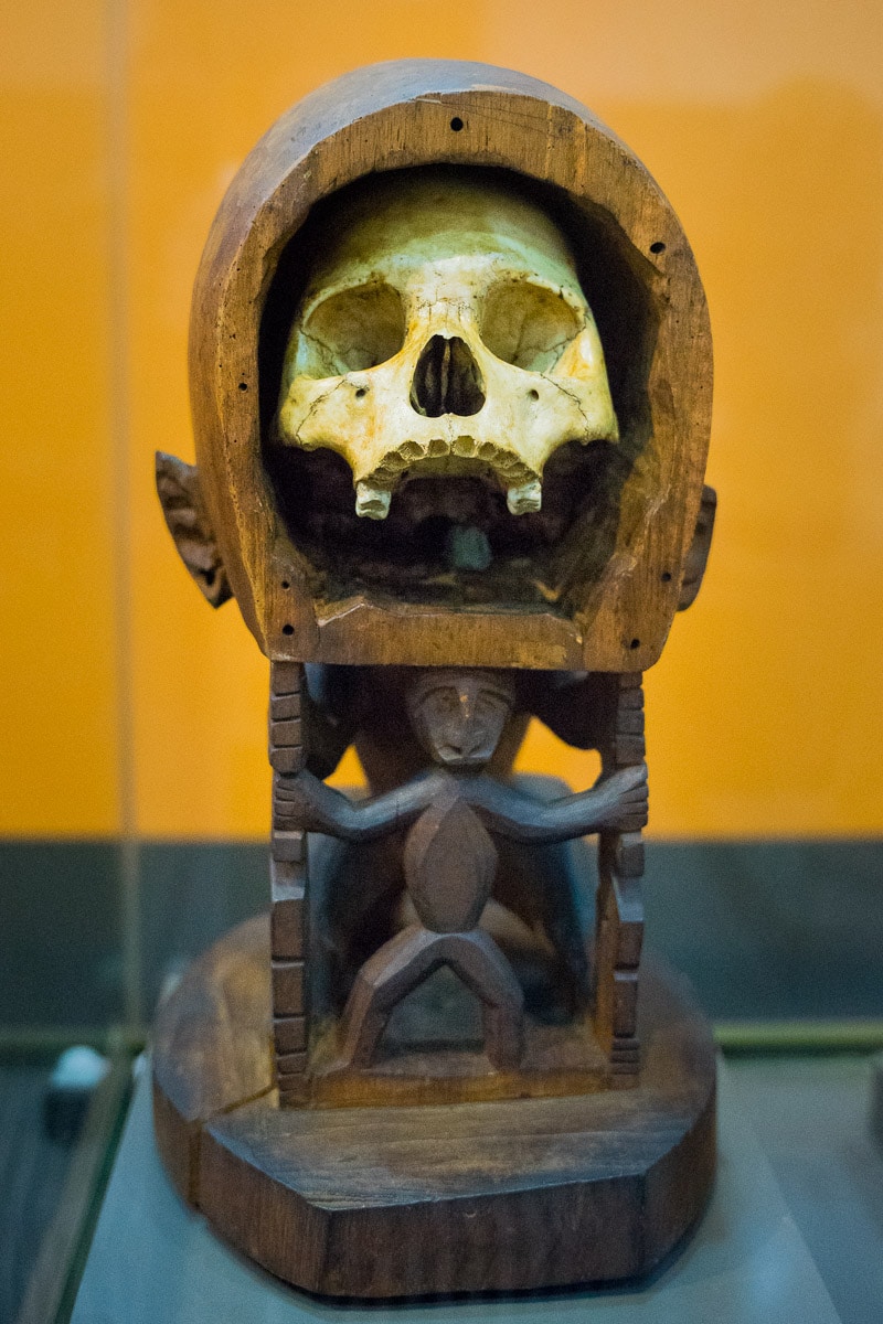 Another korwar statue of a human skull housed in a wooden figure