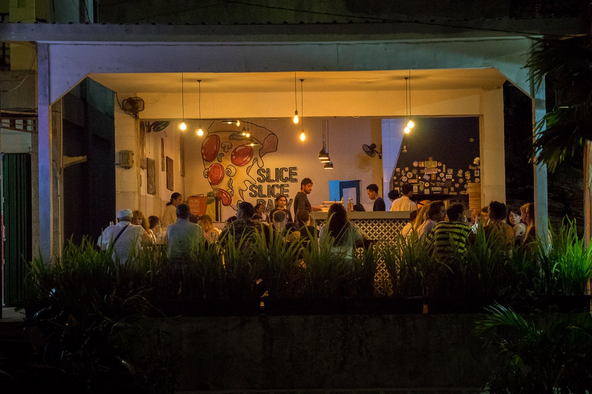 Fellas Italian restaurant seen from the Street. It's busy with diners and and the owner is seen managing the kitchen
