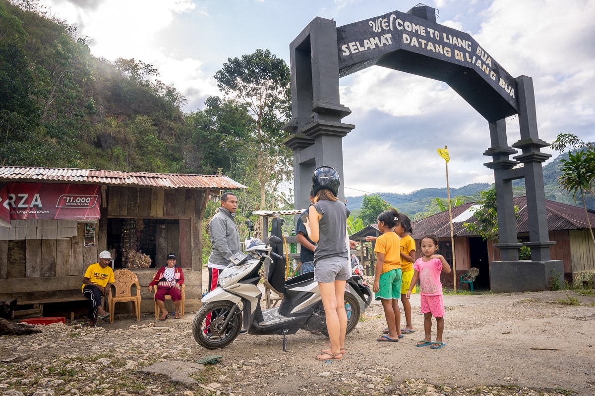 We are filling our scooter tank with petrol at the entrance to Liang Bua (Hobbit Cave) near Ruteng