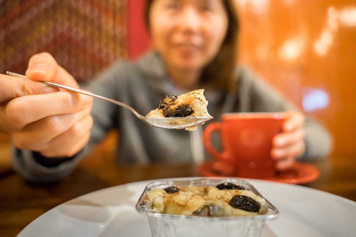 Jin is eating a klappertaart at Pasketa Coffee in Ruteng