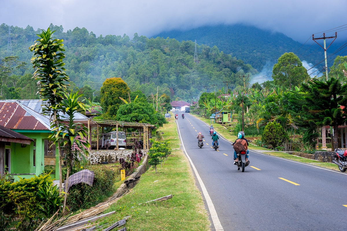 Scooters riding on the main road leading to Ruteng, Flores