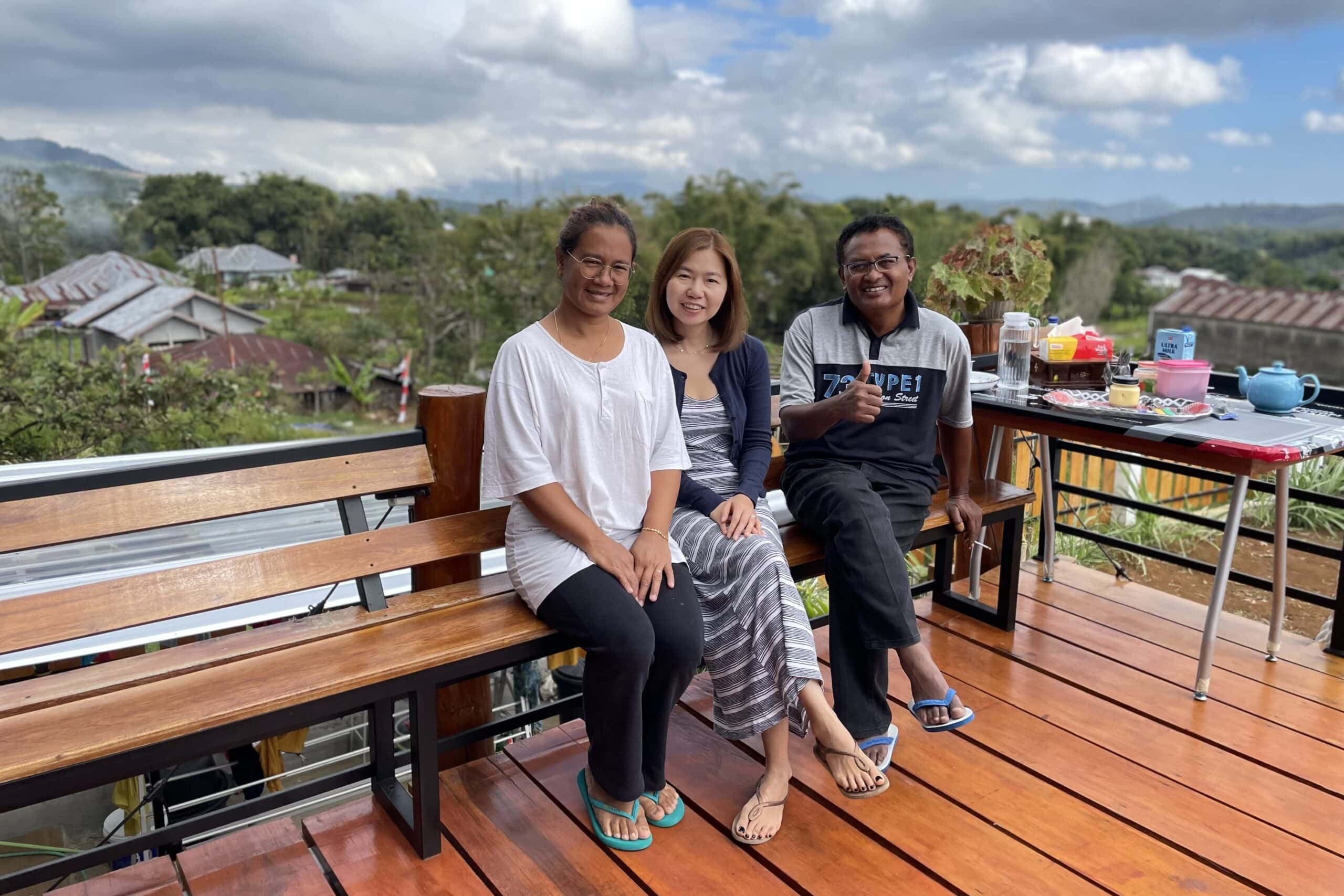 Jin and our hosts sitting on the deck in their back yard and talking about our plans and things to do in Ruteng