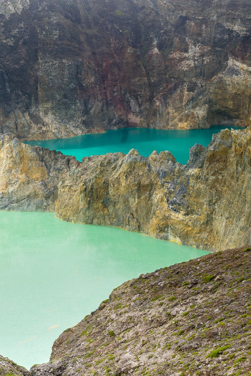 Two lakes in different shades of blue, see at Kelimutu on the Indonesian Island of Flores