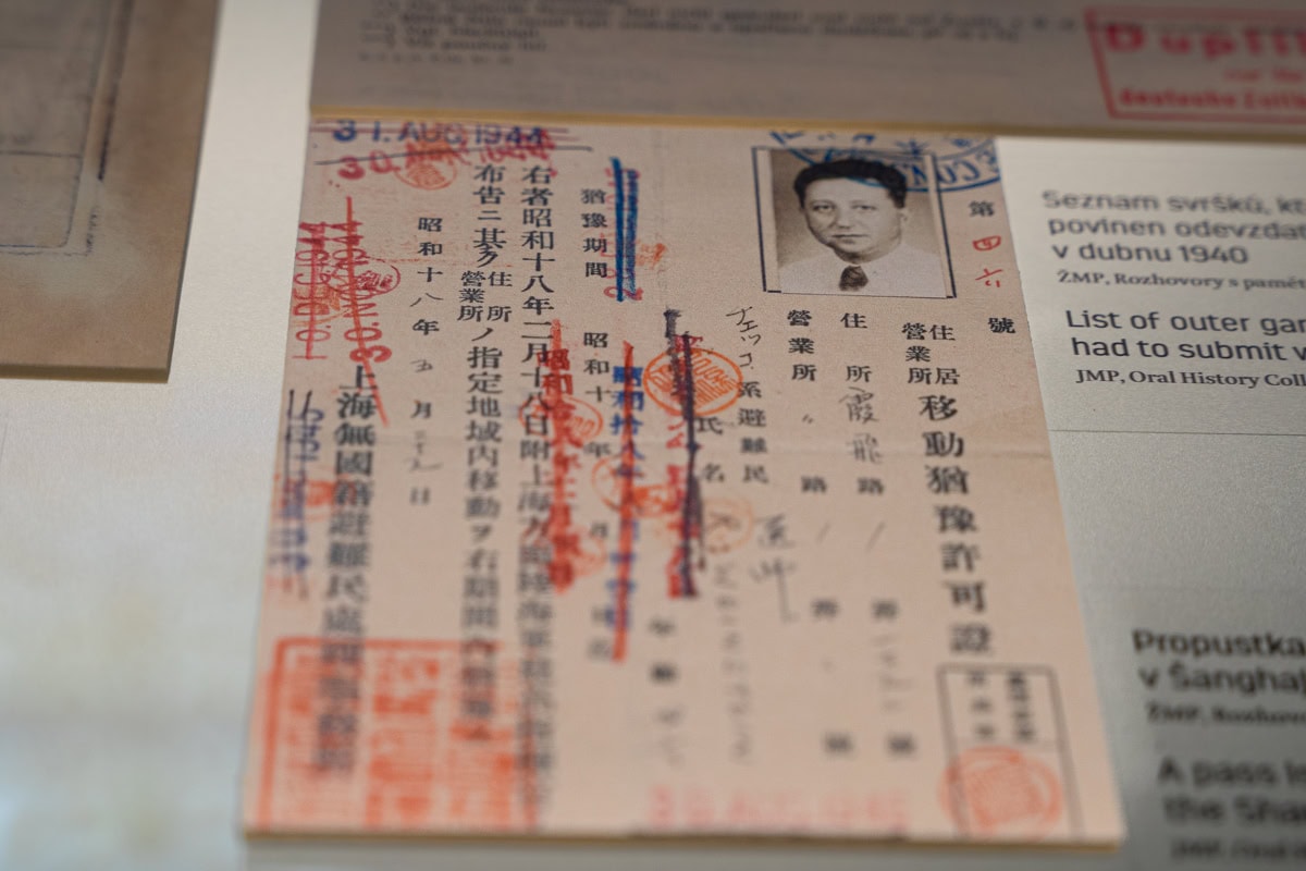 A photo of a pass issued to a Jew in the Shanghai ghetto, seen on display in the Spanish Synagogue. There is a black and white photo of a man with writing in Mandarin Chinese