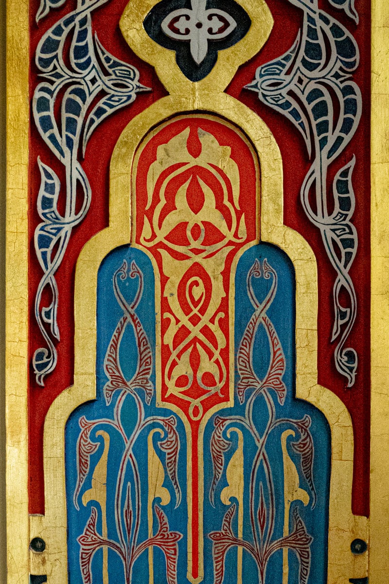 Detail of the architecture of the Spanish Synagogue. It's ornate with curly motives in gold, red, teal, white and black