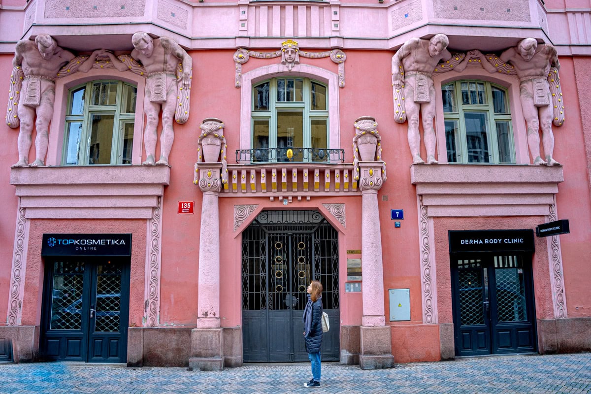 Jon stands in front of a beautiful pink building with 4 atlases supporting the architecture. We found this building on our walking tour of Prague's Jewish quarter, near the Spanish Synagogue