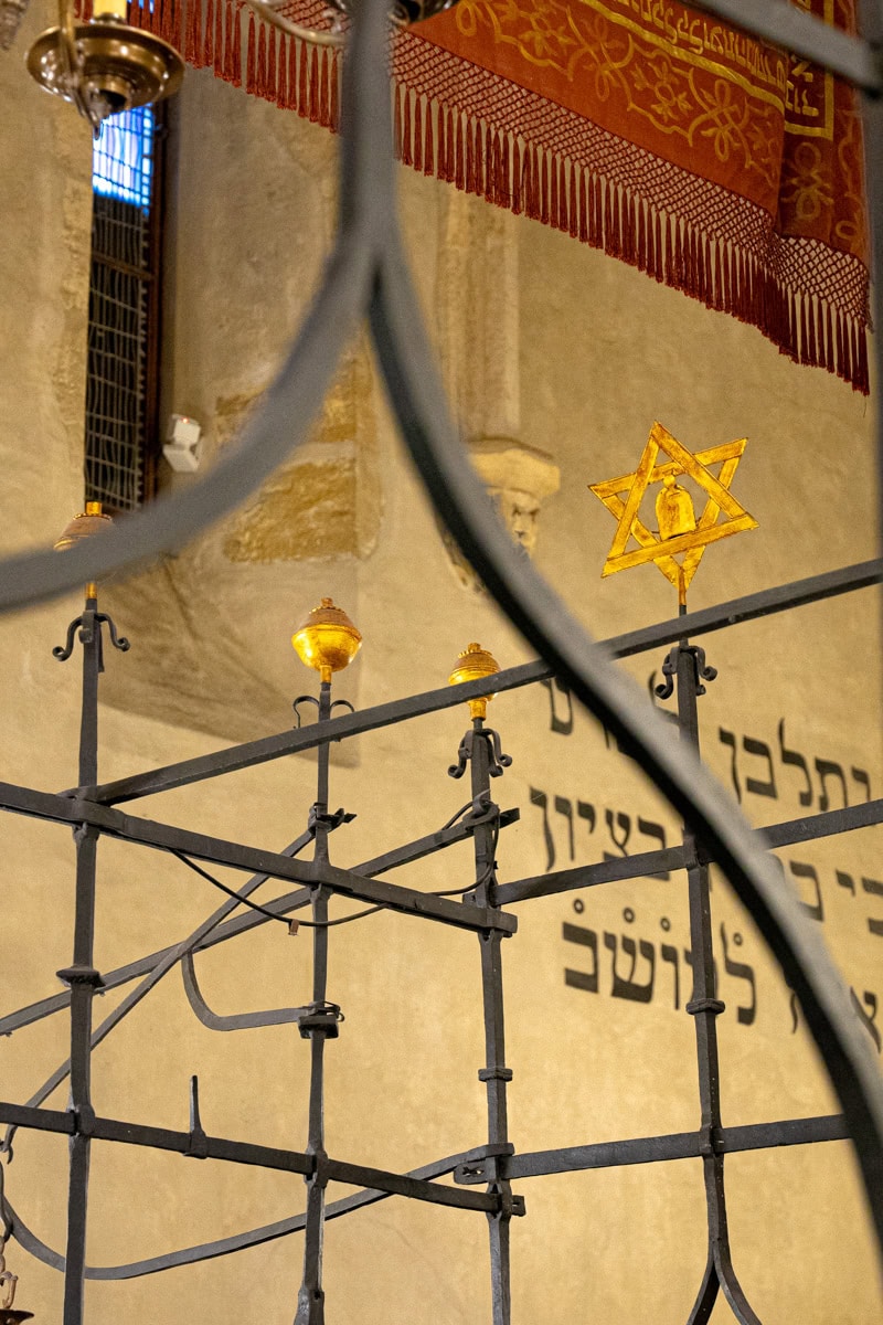 A detail of the Torah Ark inside the Old New Synagogue. A golden Star of David sits on top of the wrought iron railings
