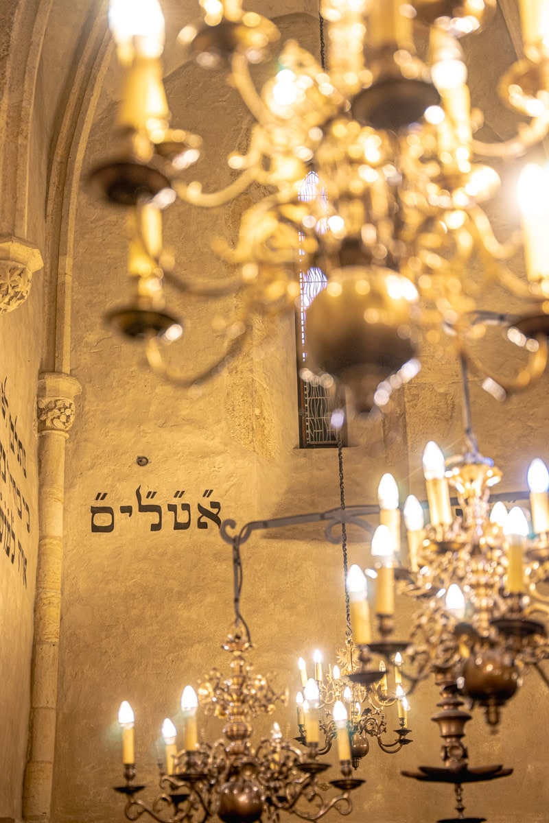 Hebrew writing seen through chandeliers inside the Old New Synagogue in Prague