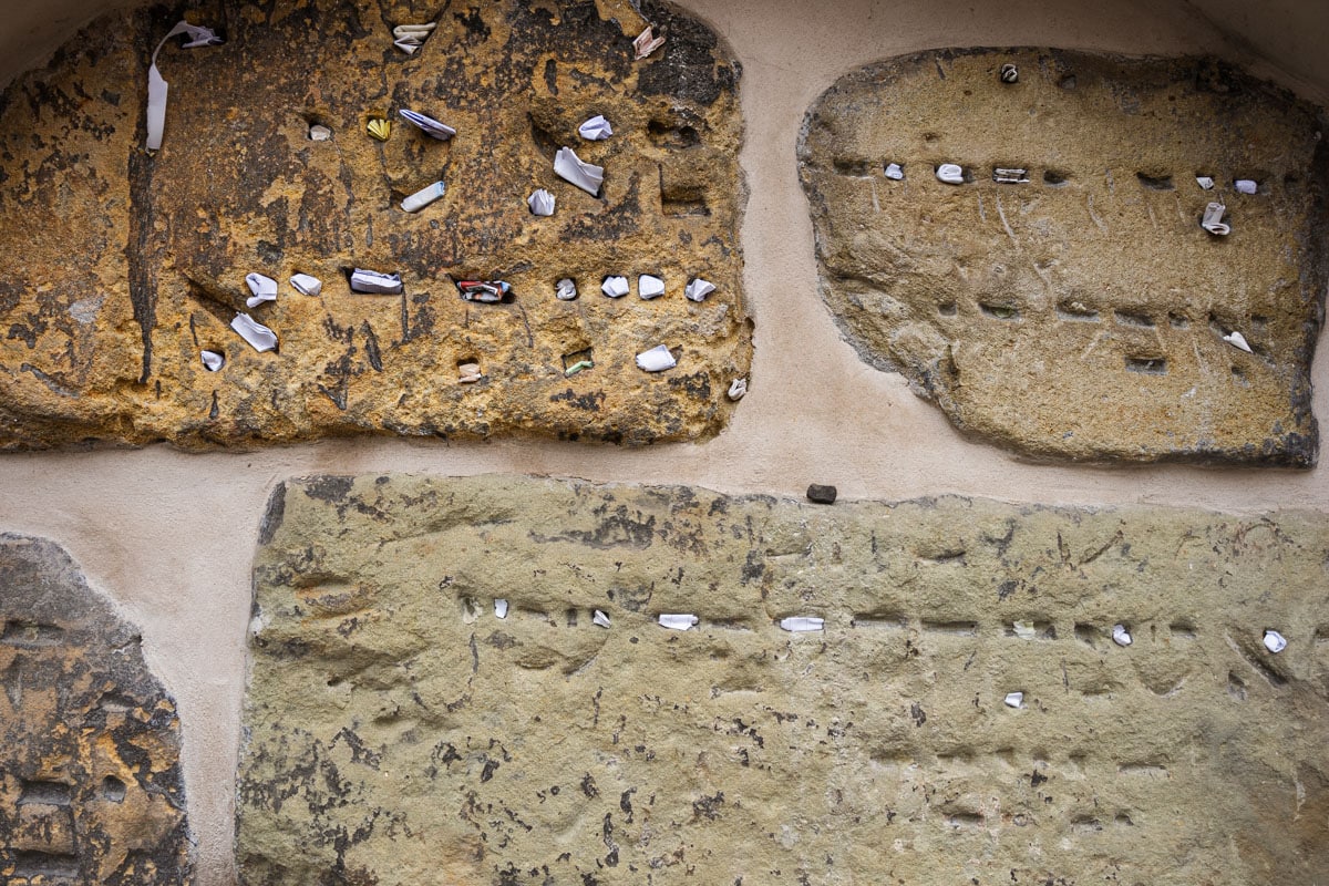 Notes stuffed into rocks in the Old Jewish cemetery. They are to ask for protection from the golem, a mythical creature that protects Jews