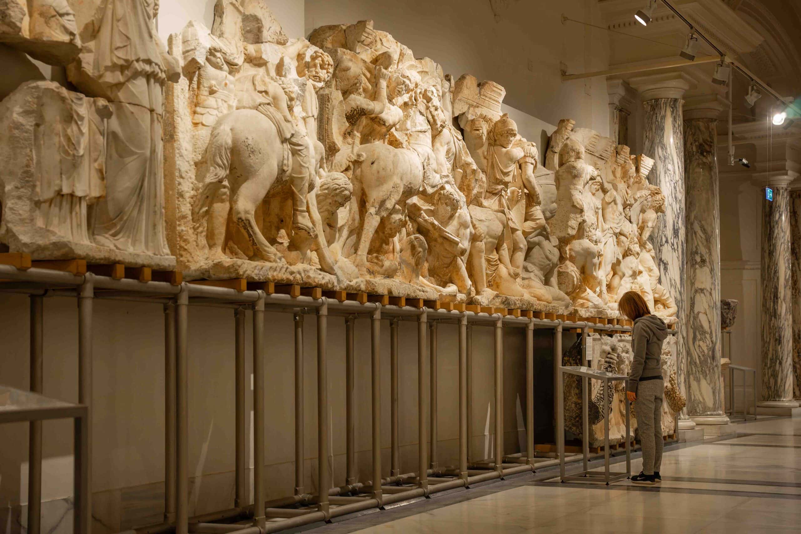 Jin reads information at a section of the Parthian Monument