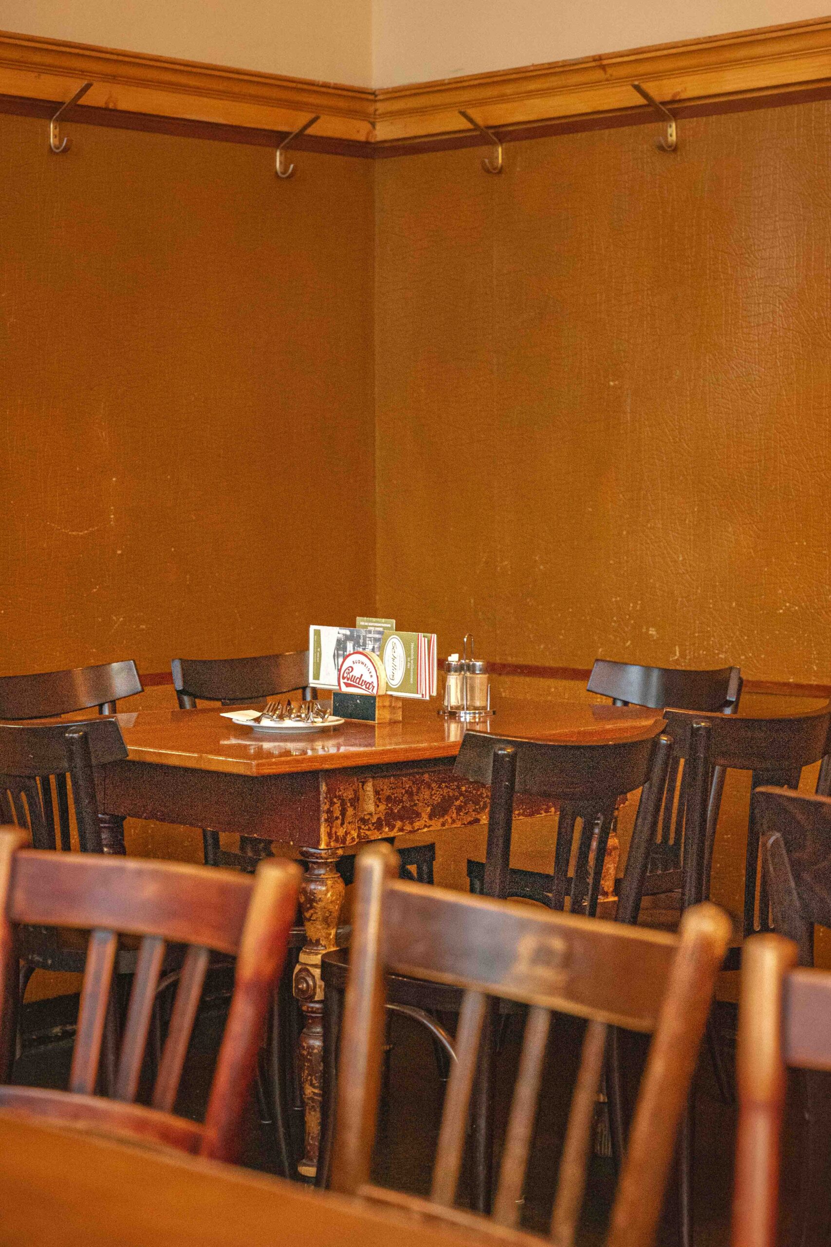 Interior of Gastwirtschaft Schilling in Vienna. You can see wooden tables and chairs against wood - panelled walls