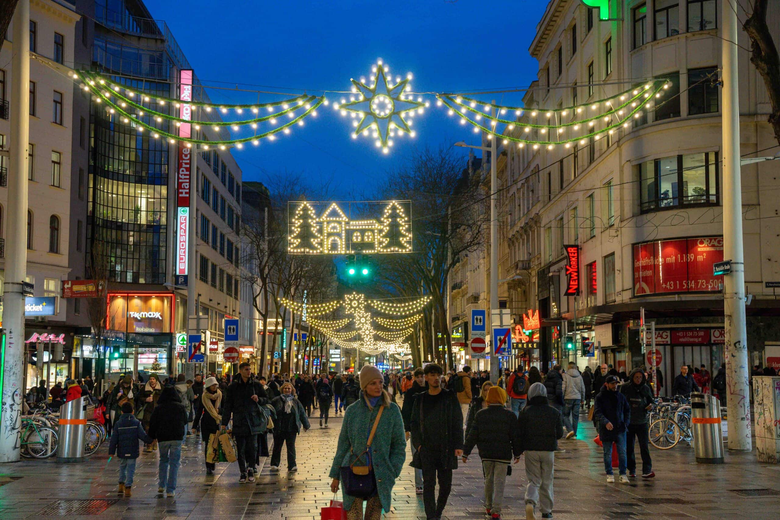 Mariahilfer Street seen in Decemebrr with shoppers strolling under Christmas lights