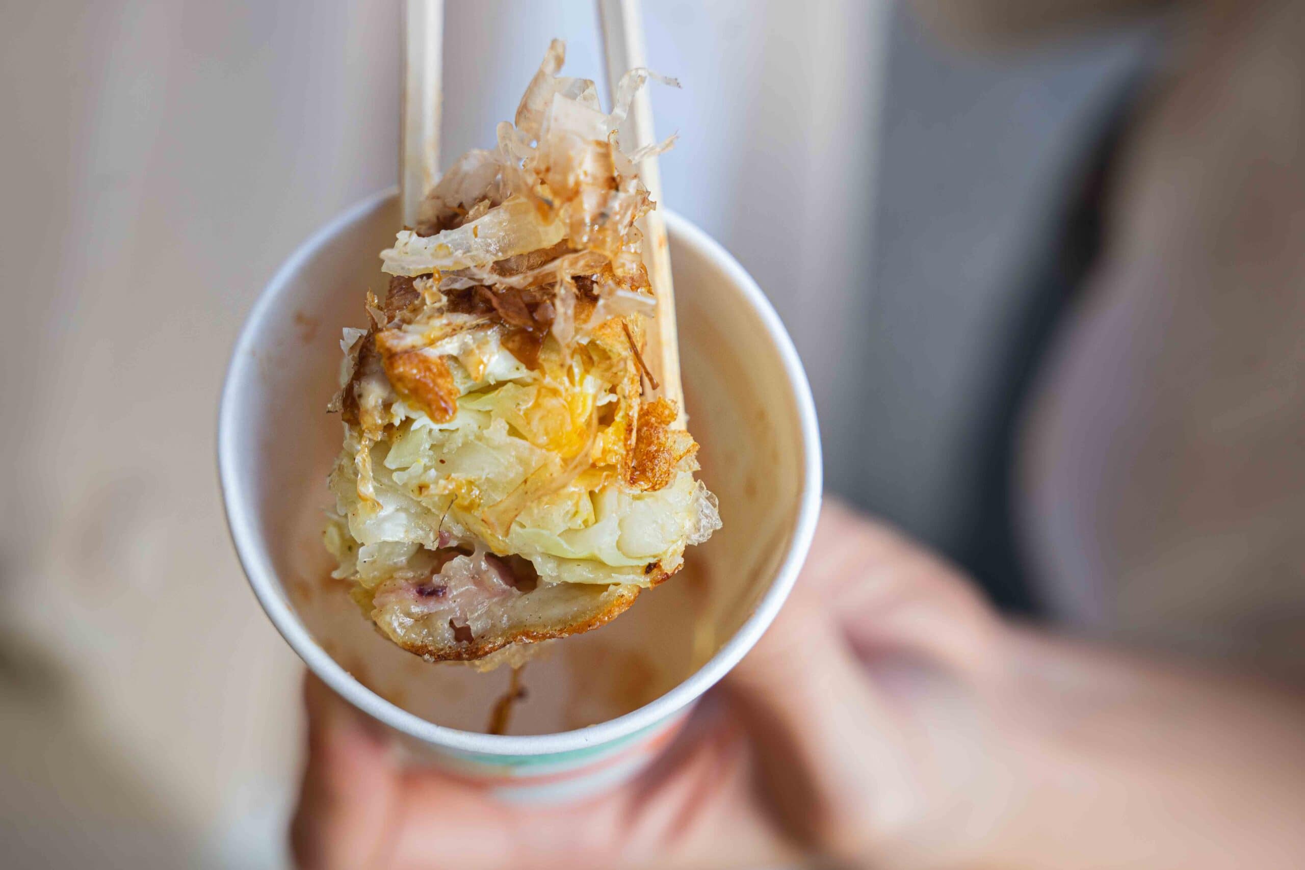 A close-up of the baked waffle showing it's filled with cabbage, bacon, octopus and shrimp