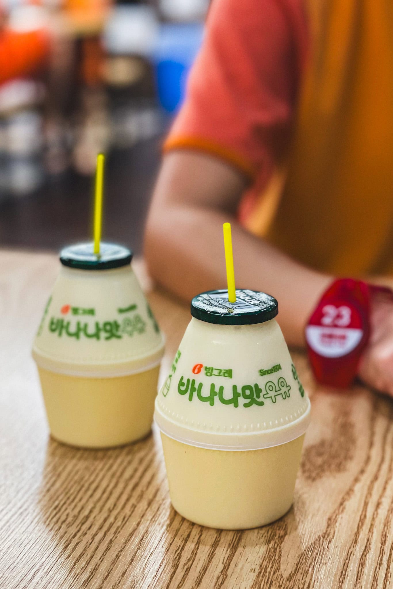 Our two banana milk bottles with cute little yellow straws that we had at the restaurant inside Sparex jjimjjilbang