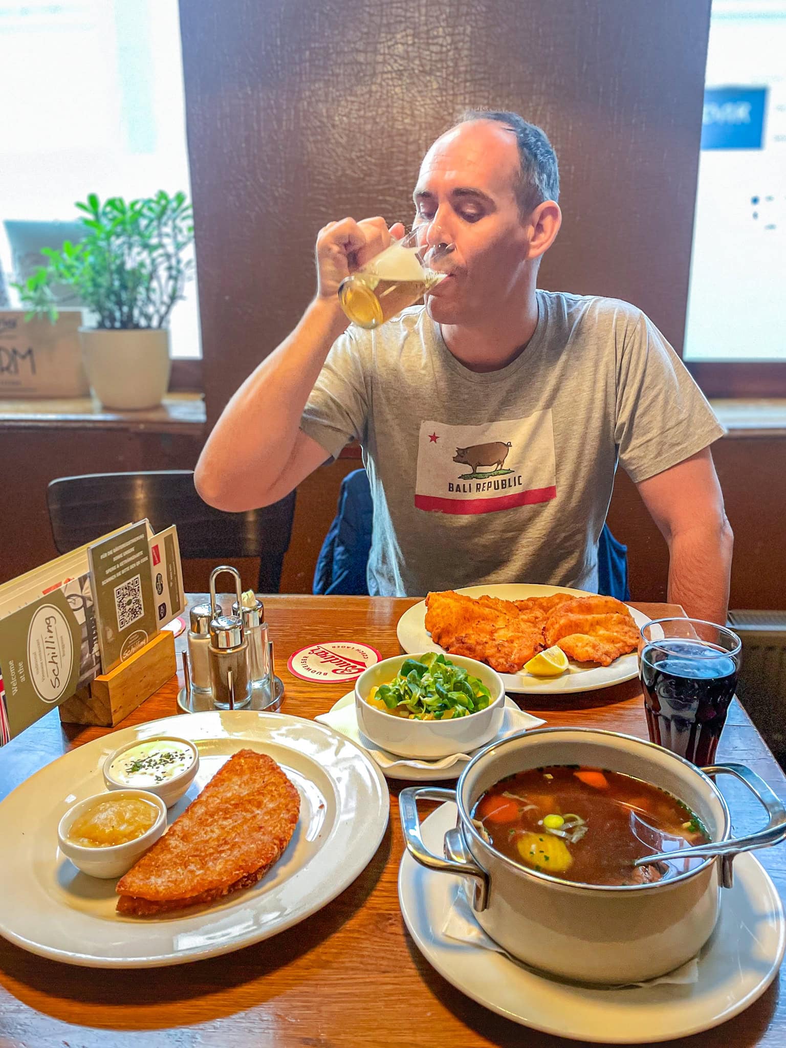 I am taking a sip of my draft beer at Gastwirtschaft Schilling, a bistro inn Vienna. On the table, you can see my Wiener Schnitzel, potato salad and Jin's Tafelspitz