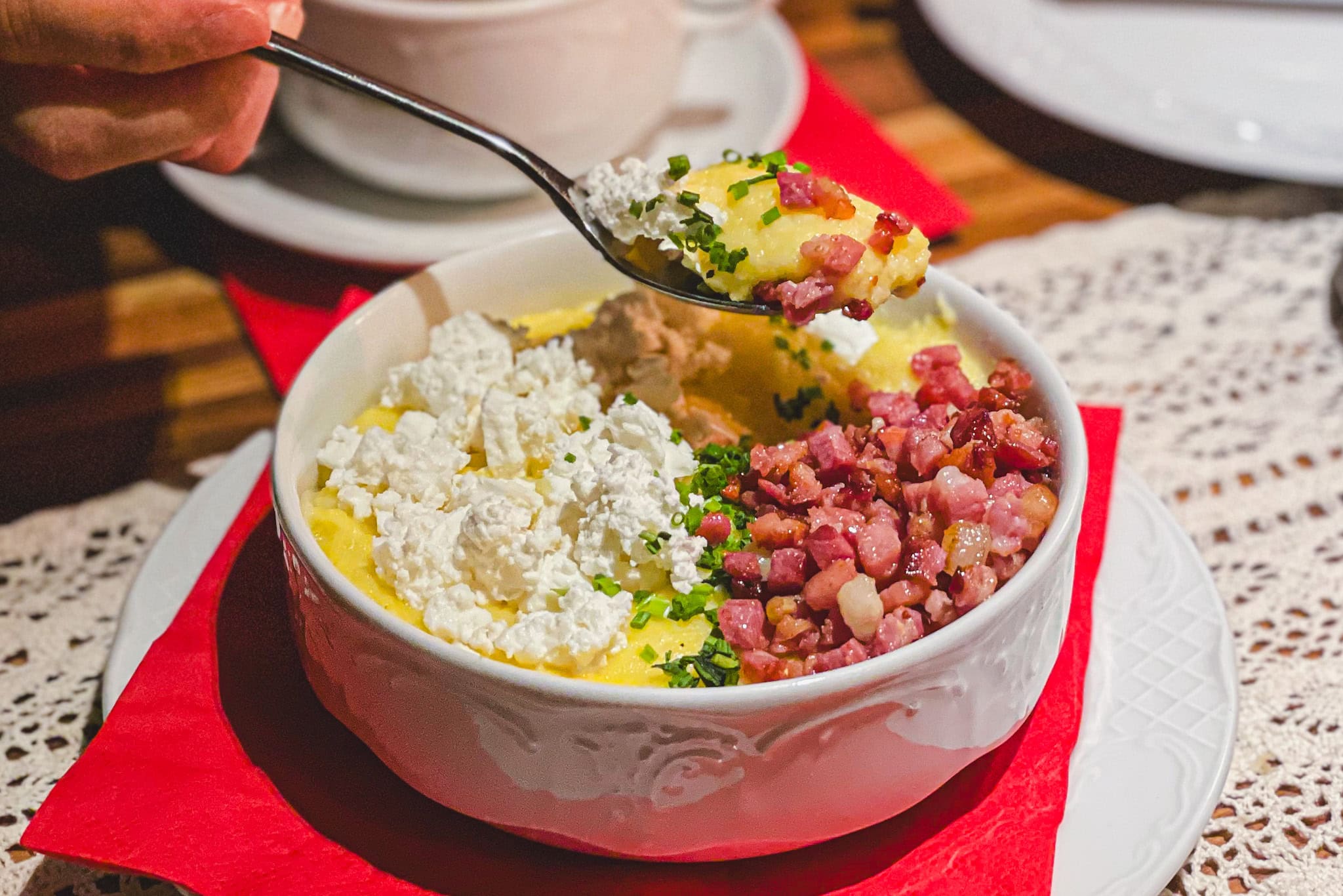 A bowl of banosh Bukovyna, a Ukrainian dish of corn grits, cheese, sour cream and topped with fried bacon which we had at Grnd Restaurant in Vienna. It was delicious!
