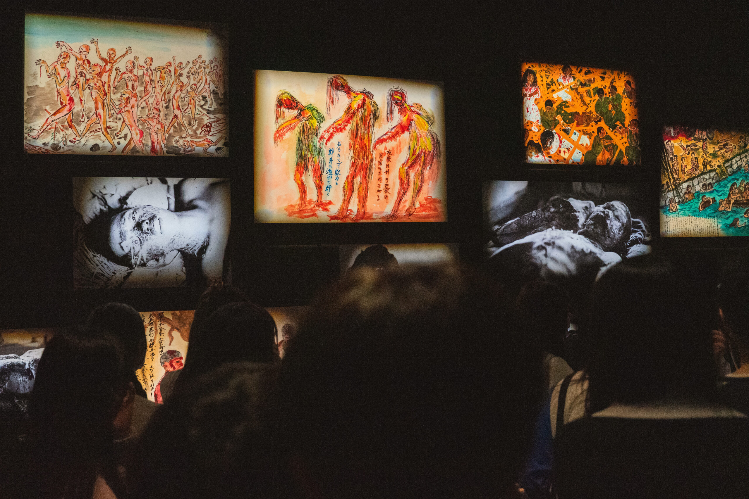 Photos of victims and drawings depicting the atomic bomb inside the Hiroshima Peace Memorial Museum