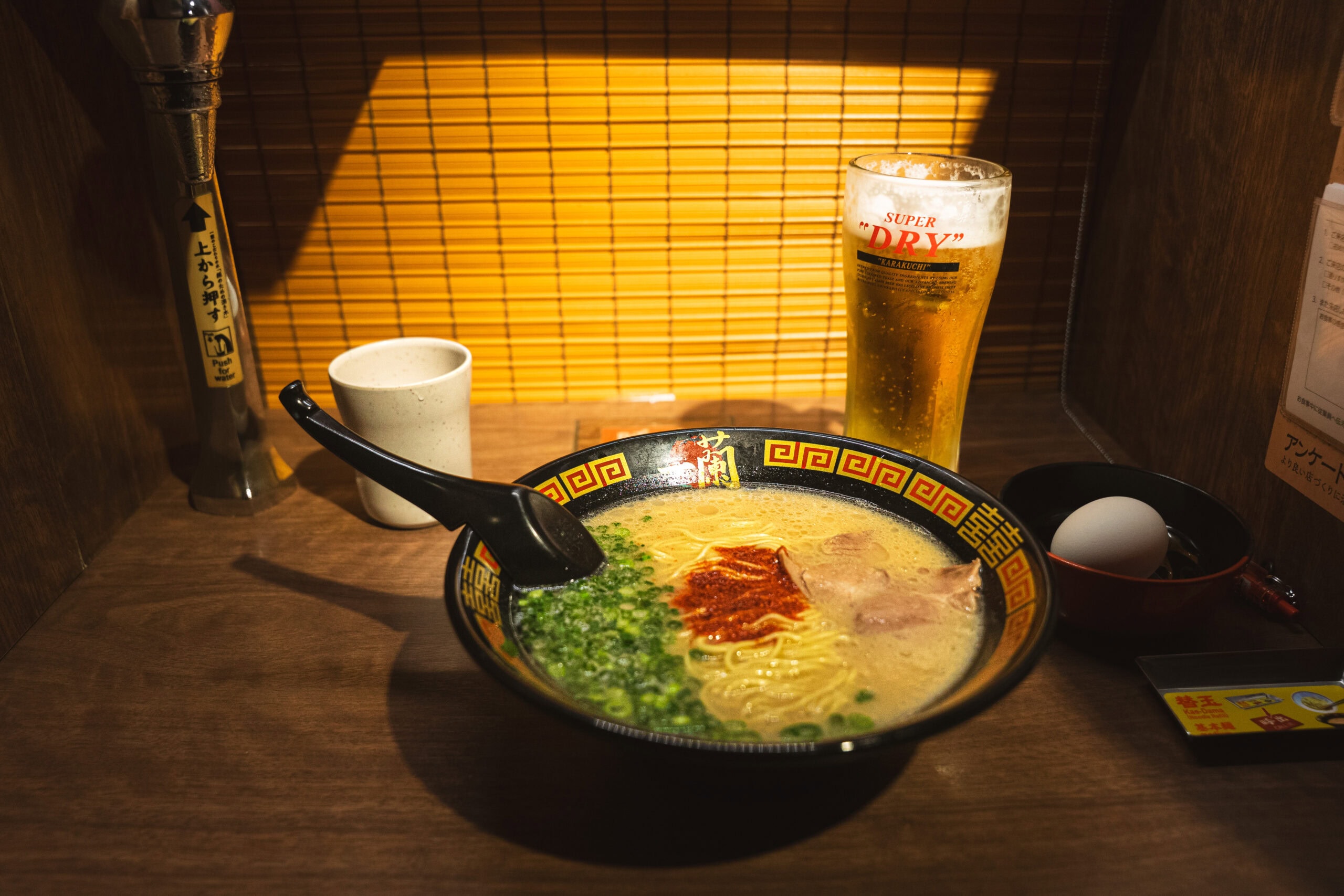 My bowl of ramen and a Super Dry beer inside my private cubicle at ICHIRAN Ramen in Hiroshima