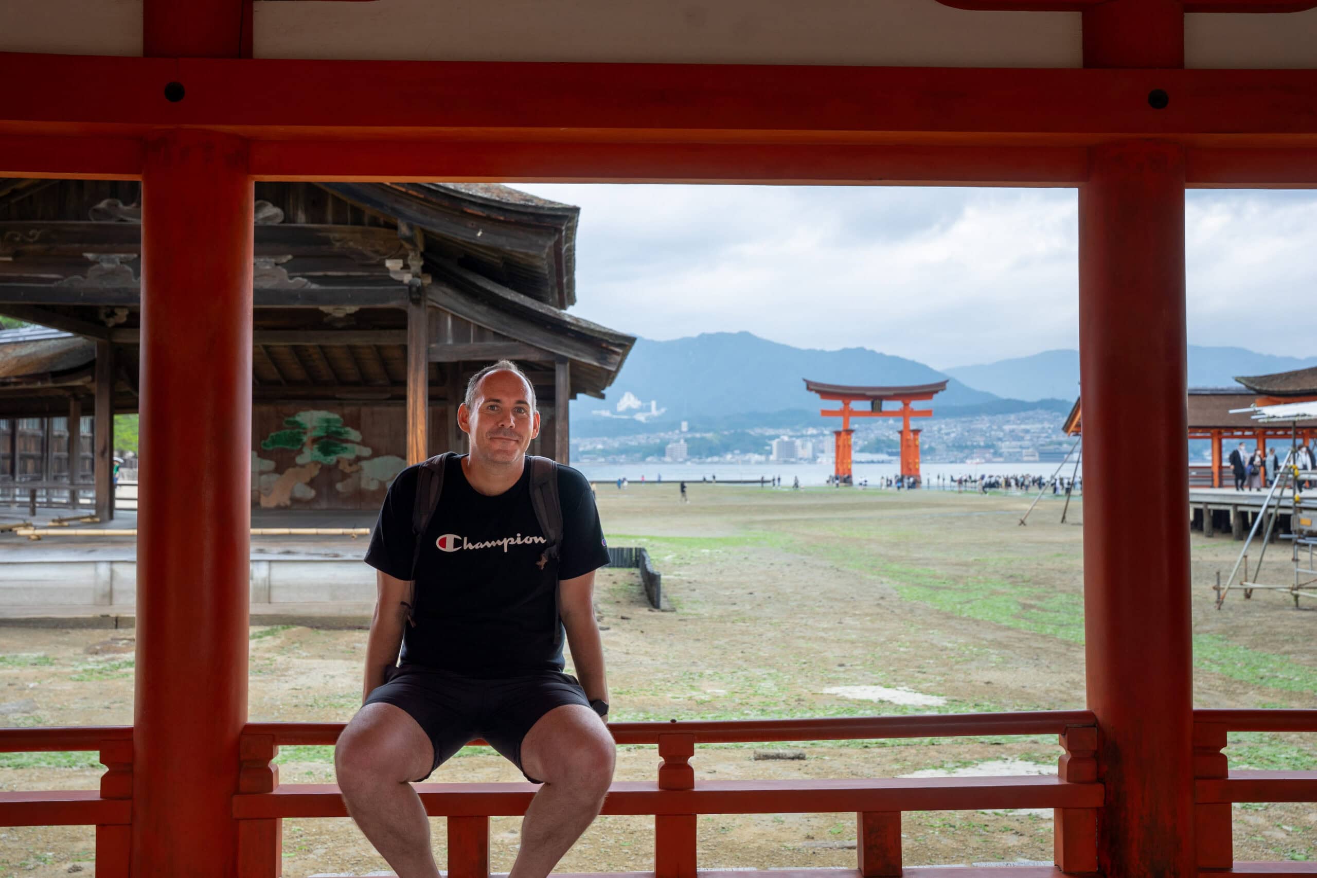 A photo of myself at Itsukushima Shrine. You can see the torii  gate in the back ground