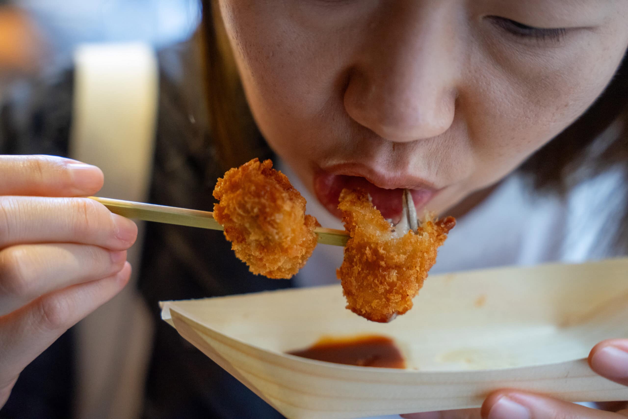Jin eating fried oysters on Omotesando Shotengai on Miyajima Island